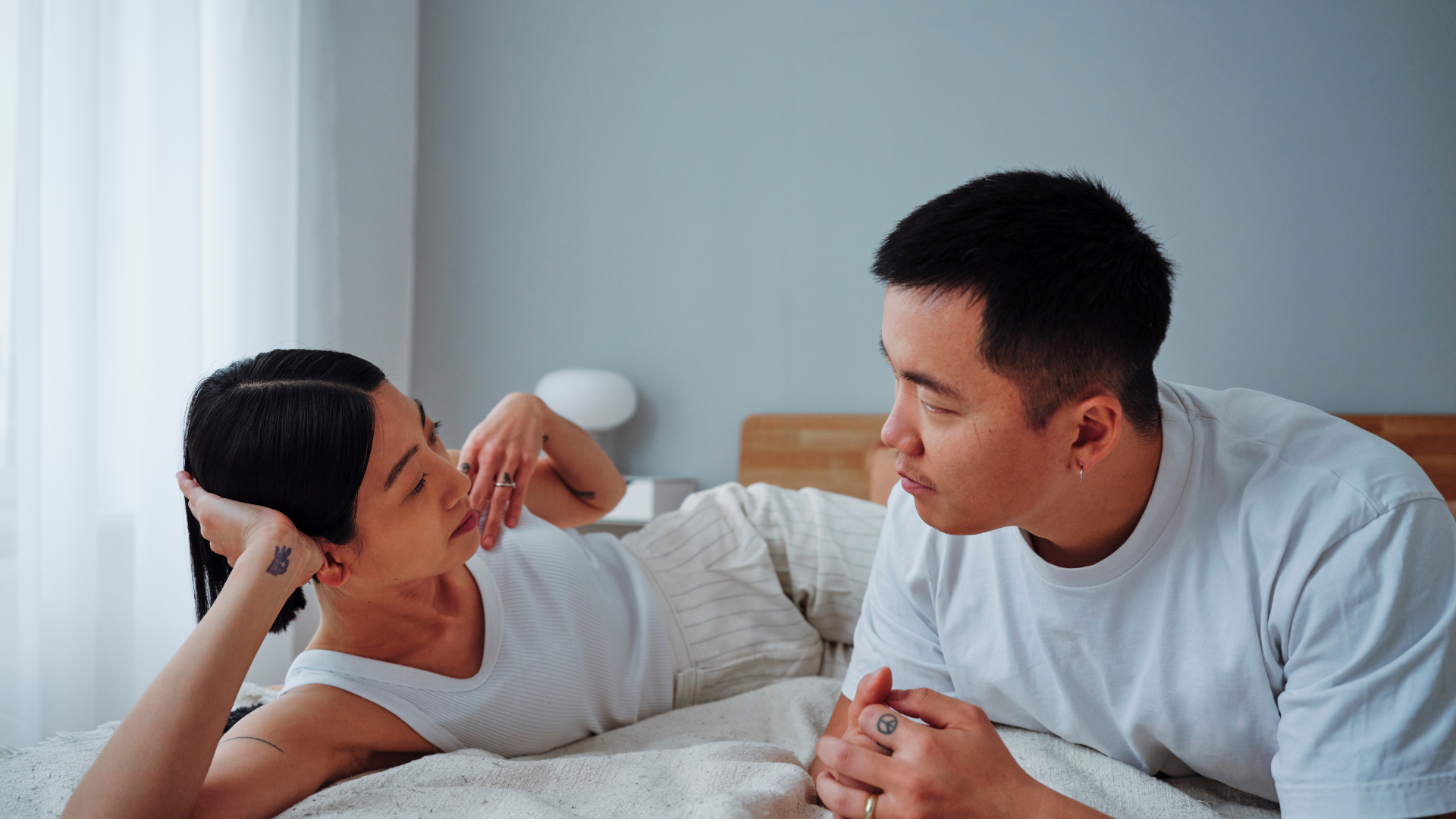 couple is in bed communicating openness and interest in each other